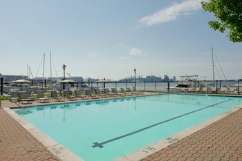 A swimming pool with a view of the harbor and the city